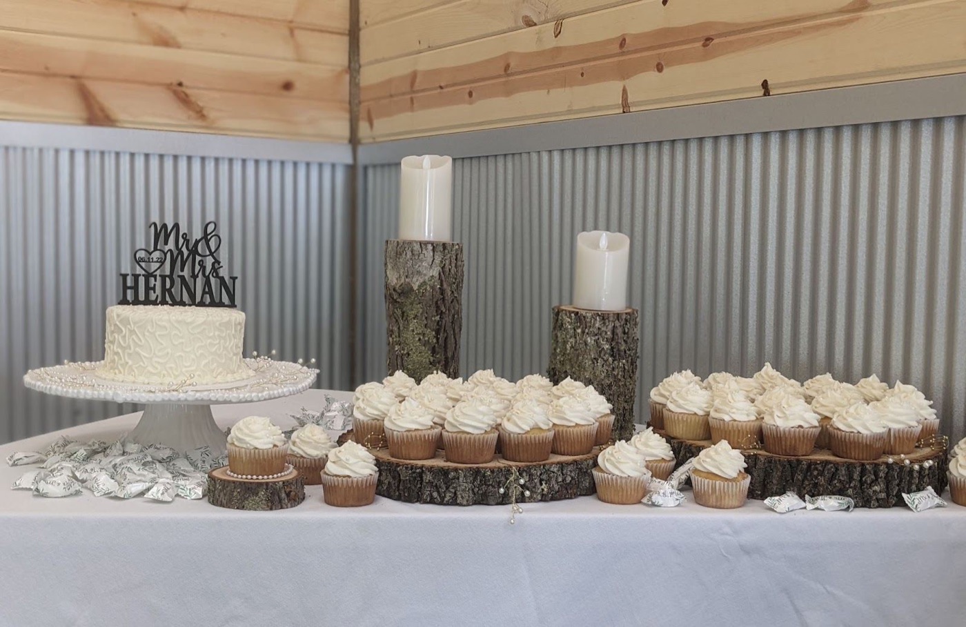 Cupcakes displayed on wood rounds at a wedding