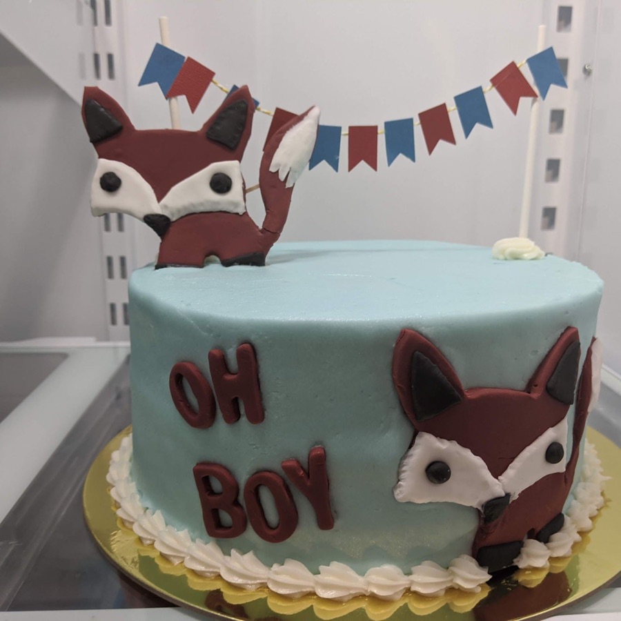 A baby shower cake with a fox and the words Oh Boy